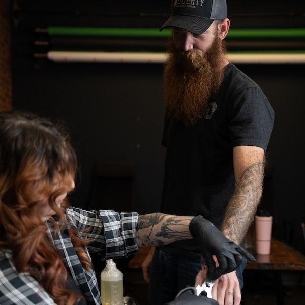 A real customer with a Live Bearded logo tattoo