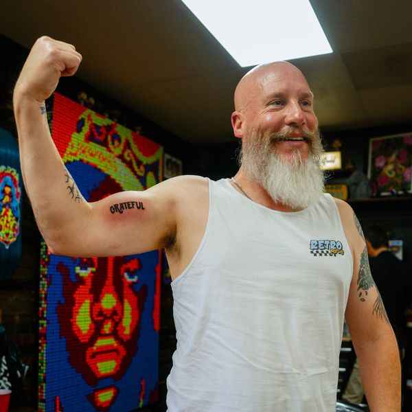 A real customer with a Live Bearded logo tattoo