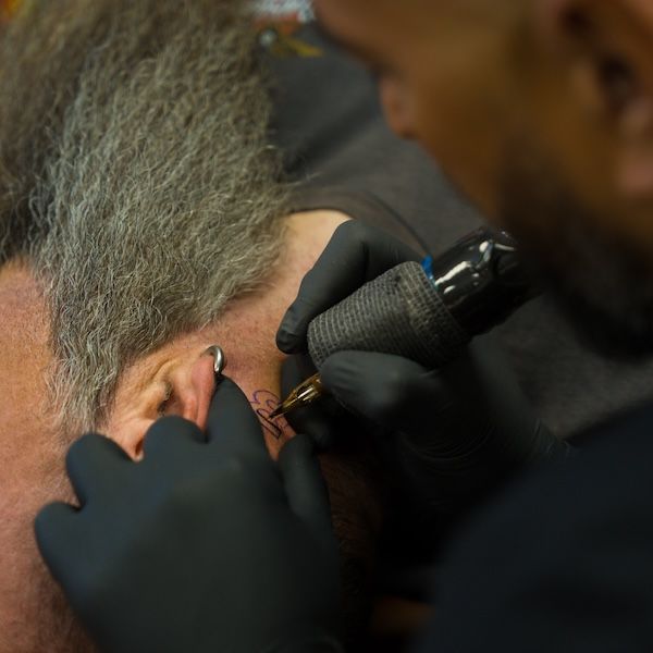 A real customer with a Live Bearded logo tattoo