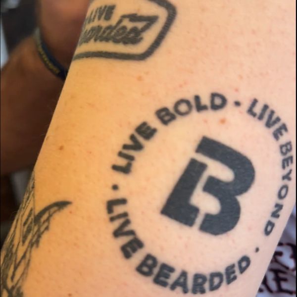 A real customer with a Live Bearded logo tattoo