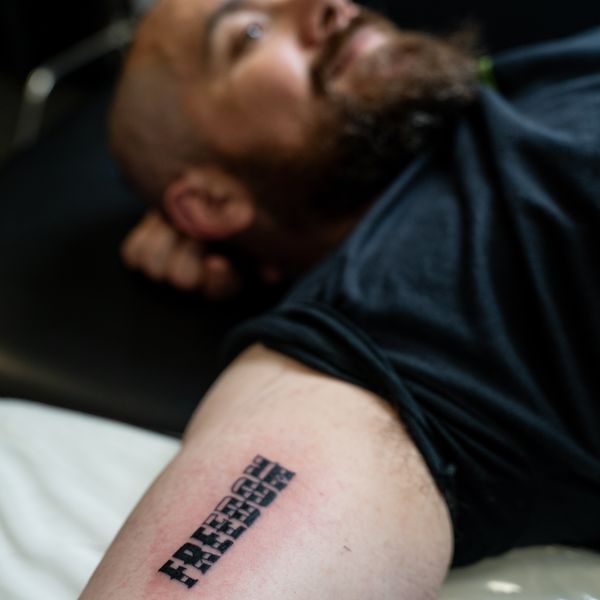 A real customer with a Live Bearded logo tattoo
